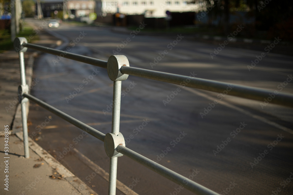 Handrail by road. Pedestrian barrier. Fence along road. Handrail by road. Pedestrian barrier. Fence along road.