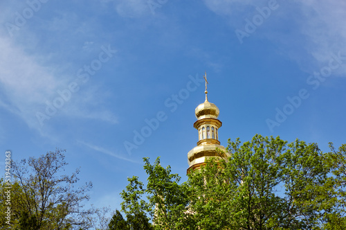 Kiev, Ukraine. Church building architecture, Pechersk Lavra monastery with golden cupol against blue sky background photo