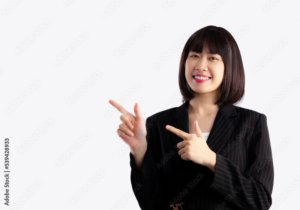 Asian businesswoman short hairstyle in black jacket suit fingers pointing on white background.
Asian businesswoman short hairstyle in black jacket suit fingers pointing on white background.