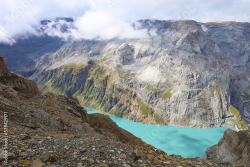 Limmerensee reservoir surrounded by Muttenchopf mountain and Muttsee mountain lake in Glarus, Switzerland photo