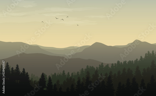 Morning landscape with misty silhouettes of mountains and hills, forest with coniferous trees and flying bird in the yellow toned sky