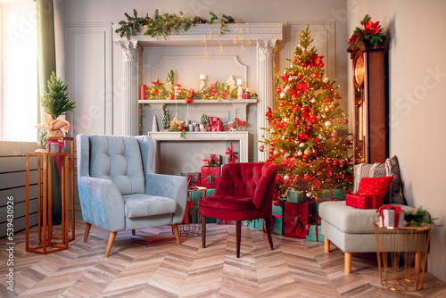 Happy new year interior christmas. Red Decorated glowing tree, two armchair, fireplace with candles and gifts