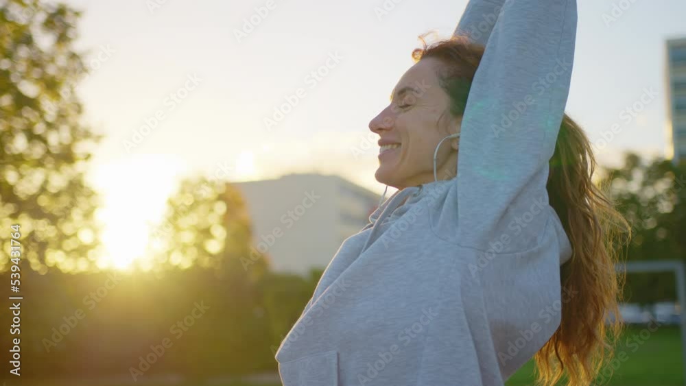 Close up of athletic young female exercising, stretching and doing yoga. Beautiful woman in sports clothes practising breathing technique and exercises