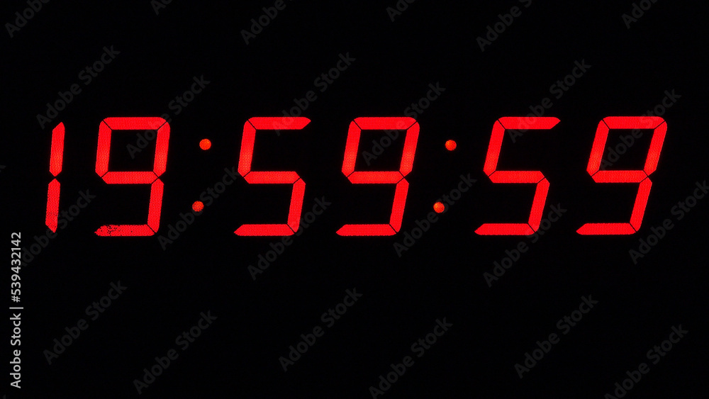 Digital timer on a black background. Light panel with red numbers. 20 o'clock