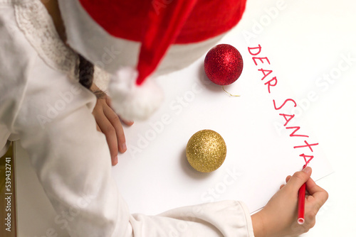 Child is writing letter to Santa at Christmas