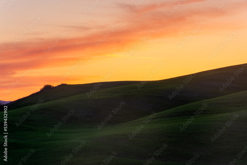 Beautiful  sunset over the countryside hills of Tuscany