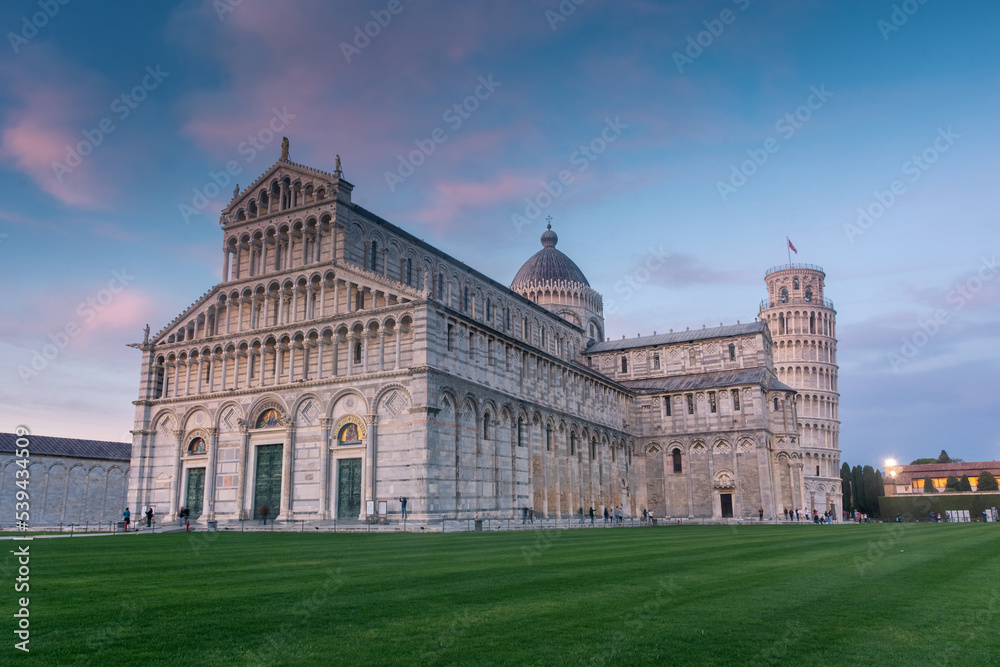 Pisa, Italy,  14 April 2022: Cathedral and leaning tower at sunset