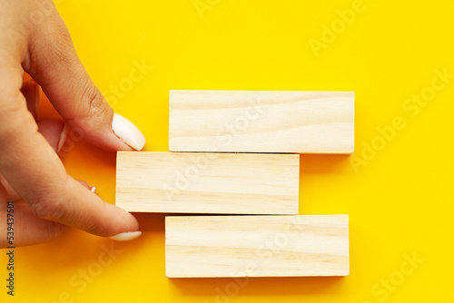Woman hand stacked wooden blocks with space for text
