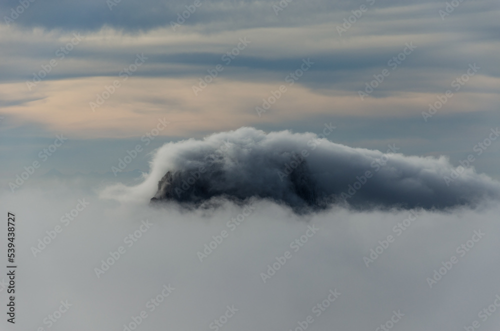 Obraz premium tip of the island of Es Vedra in Ibiza rising out of the mist in winter
