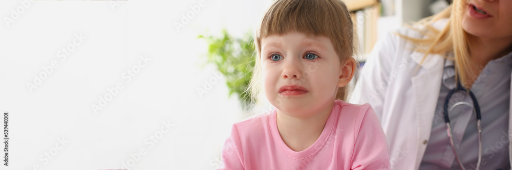 Girl cry at doctor office on consultation, upset little girl dont like hospital Girl cry at doctor office on consultation, upset little girl dont like hospital