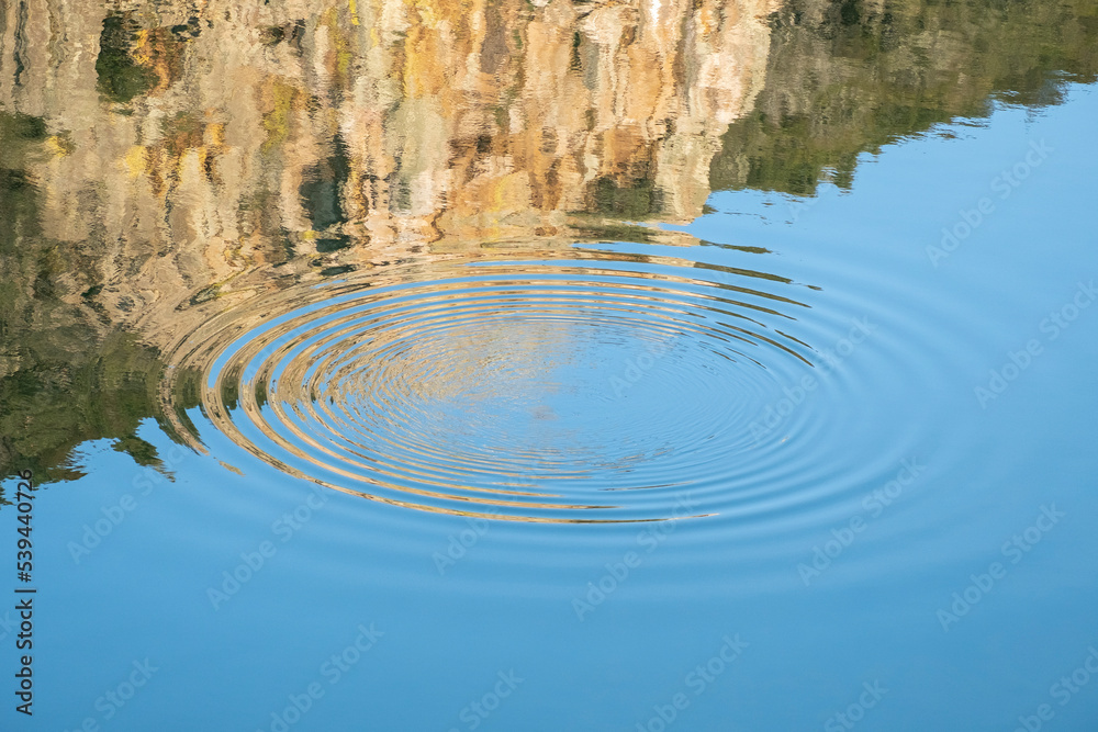 Circular waves in the water produced by the jump of a fish in the waters of the Tagus River in the area known as Salto del Gitano in Monfrague National Park Circular waves in the water produced by the jump of a fish in the waters of the Tagus River in the area known as Salto del Gitano in Monfrague National Park