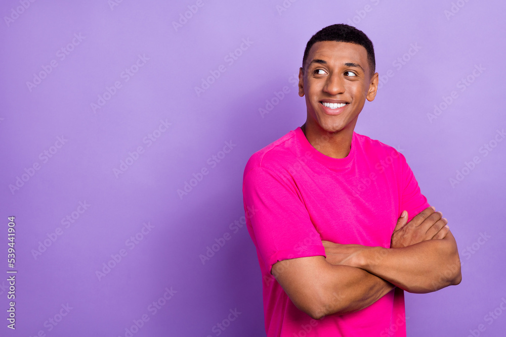Portrait of optimistic satisfied man with fade haircut wear pink t-shirt arms crossed look empty space isolated on violet color background