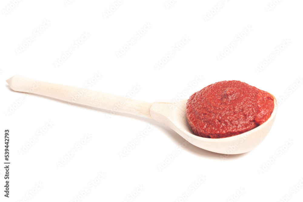 natural tomato paste in wooden spoon isolated on white natural tomato paste in wooden spoon isolated on white