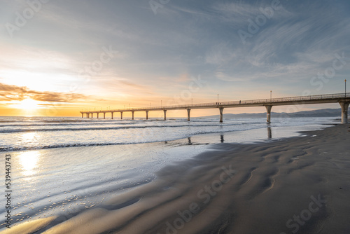 Beautiful sunrise at New Brighton Pier  Christchurch  New Zealand. It is one of eastern country s main entertainment and tourist centers  with its architecturally unique pier and scenic coastline.