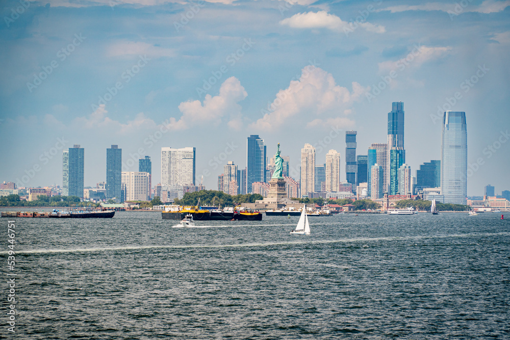 Fototapeta premium Jersey City, NJ. USA - August 20, 2022: Skyline of Jersey City with the Statue of Liberty from the Staten Island ferry