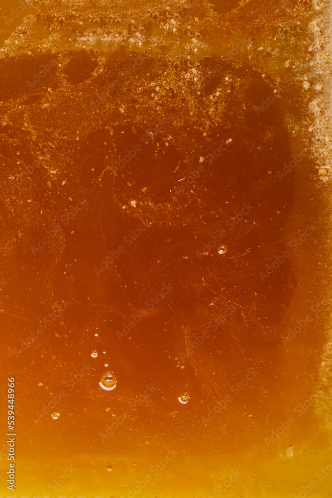 Surface texture of liquid light golden color with air bubbles of bee honey. Healthy food. Surface texture of liquid light golden color with air bubbles of bee honey. Healthy food.