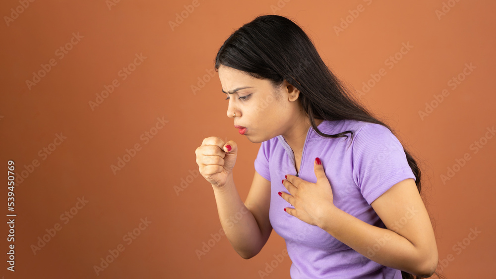 Young woman over isolated background is suffering with cough and feeling sick