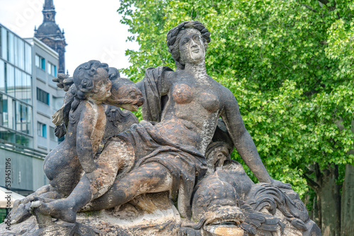 Dresden  Germany  Old sculpture of sensual woman nymph bathing with a child and fish at the fountain in historical and museums downtown of Dresden