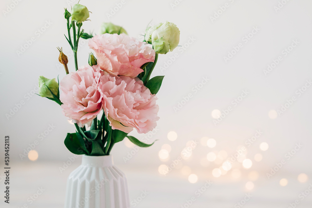 Beautiful pink bouquet of flowers in the vase on the table. Cozy home decoration and festive decor Beautiful pink bouquet of flowers in the vase on the table. Cozy home decoration and festive decor