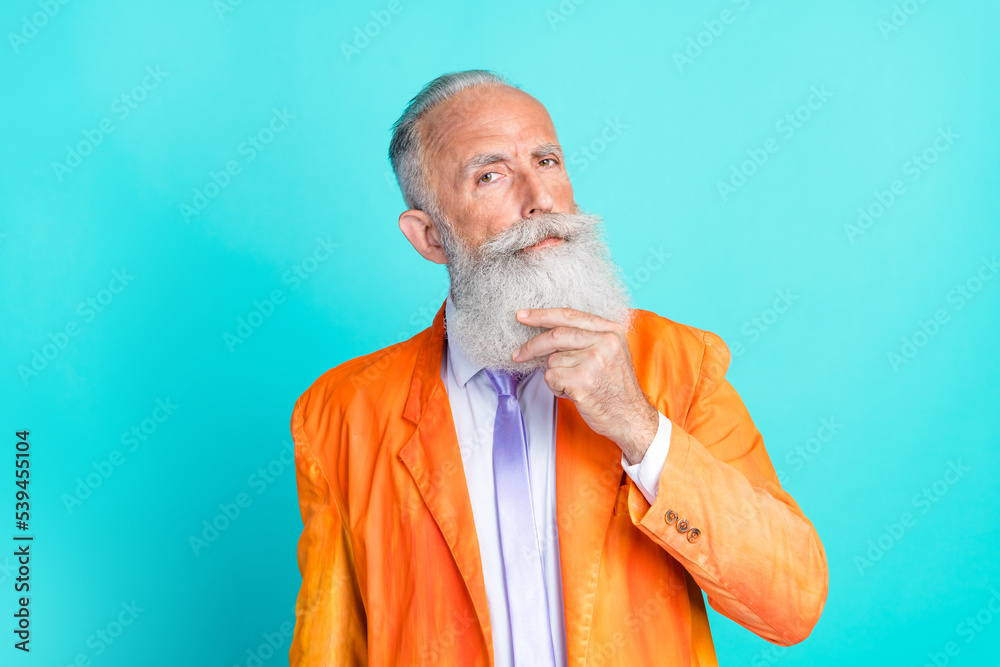 Photo of minded clever man showman artist wear fashionable clothes touch beard consider decision dilemma isolated on cyan color background Photo of minded clever man showman artist wear fashionable clothes touch beard consider decision dilemma isolated on cyan color background