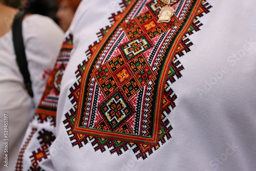 Closeup of a traditional Ukrainian embroidery on the woman's white national cloth called vyshyvanka photo