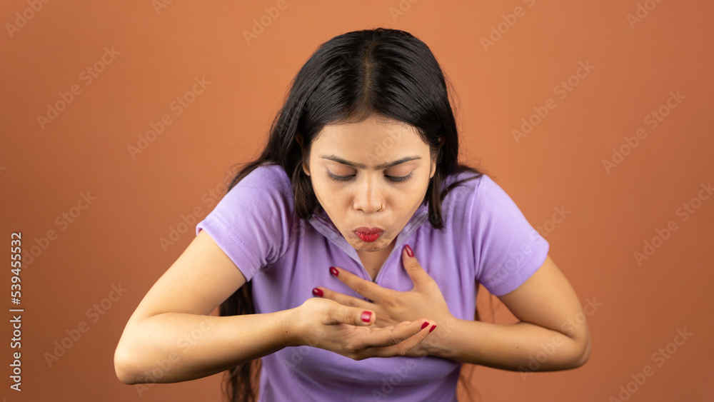 Woman suffering from stomach ache and nausea on color background Woman suffering from stomach ache and nausea on color background