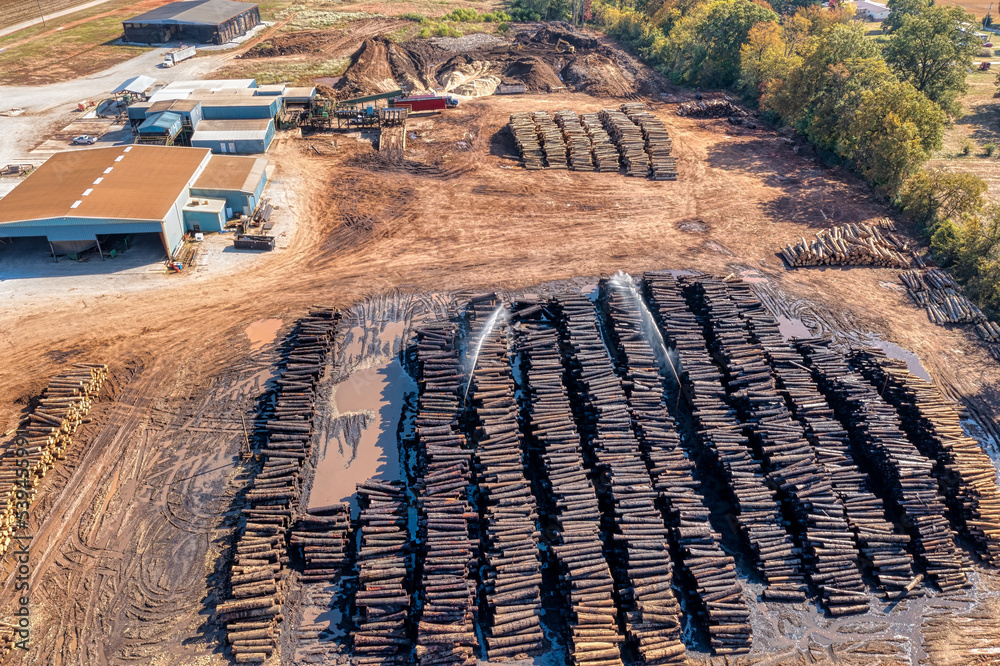 Aerial drone view of a sawmill, log stacks yard with sprinklers keeping the  logs wet, trucks and logging equipment. In Tennessee U.S.A. Photos | Adobe  Stock