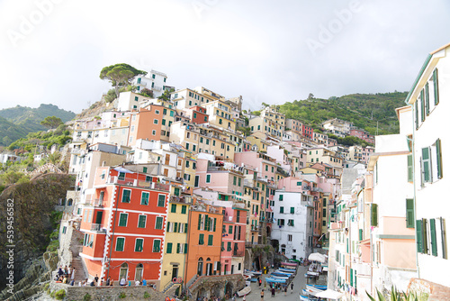 View of the colorful houses along the coastline of Cinque Terre area in Riomaggiore, Italy