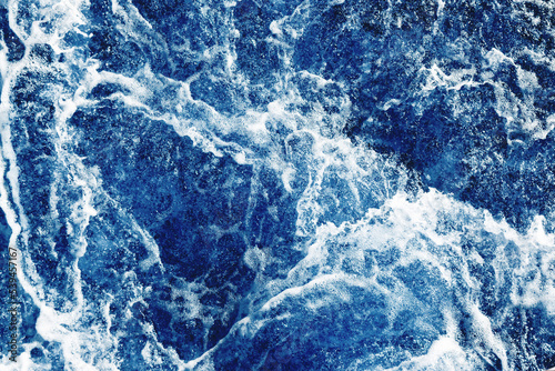 Ocean wave background. Bubble water backdrop. Turbulent sea texture. Messy water flow. Depth of the sea. Water foam surface backdrop.