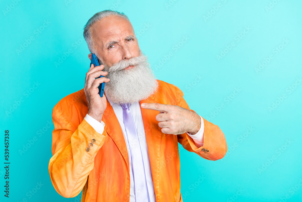Portrait of handsome serious grandfather indicate finger speak telephone isolated on turquoise color background Portrait of handsome serious grandfather indicate finger speak telephone isolated on turquoise color background