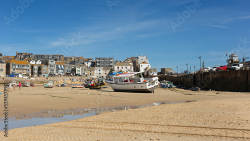 St Ives Harbour at low tide with fishing boats waiting for high tide, Corwall, UK 27 August 2022