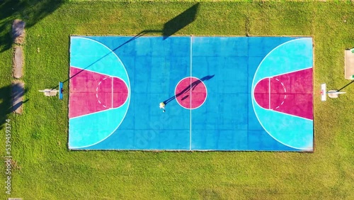 Aerial view of man playing basketball, Currimundi, Sunshine Coast, Queensland, Australia photo