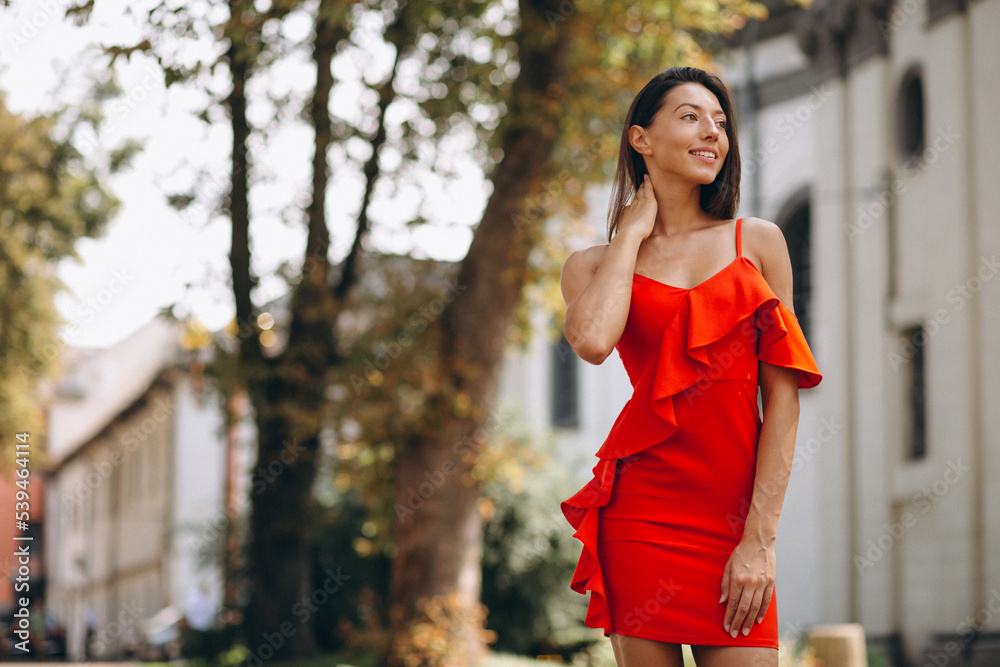 Portrait of beautiful woman smiling and wearing red dress Portrait of beautiful woman smiling and wearing red dress