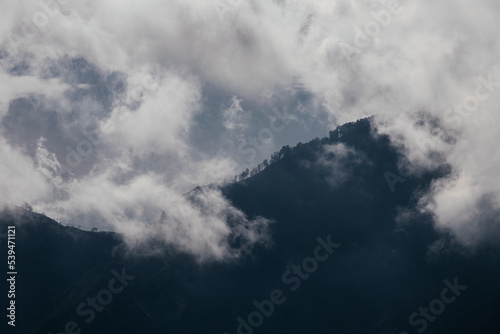 Close-up view of mountain peaks and clouds.
