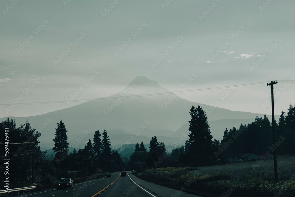 Fototapeta premium View from the Car with the road meeting Mt Hood covered in haze. 