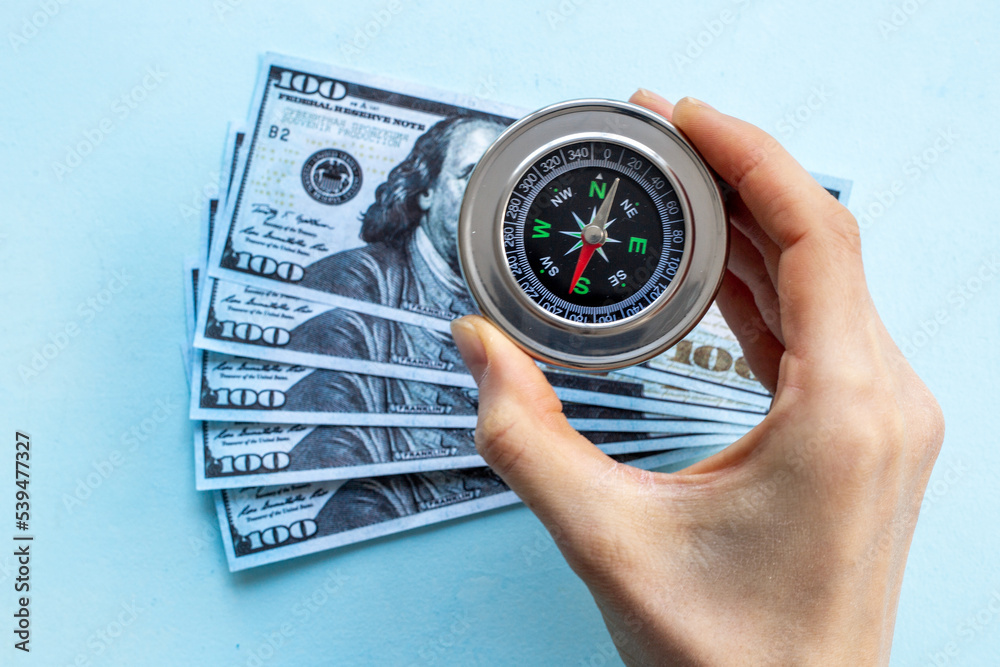 Compass and money cash - exchange rate change concept Compass and money cash - exchange rate change concept