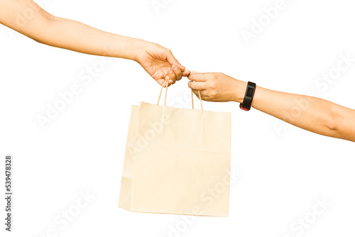 Hand holding and giving paper bag to other hand isolated in white background.