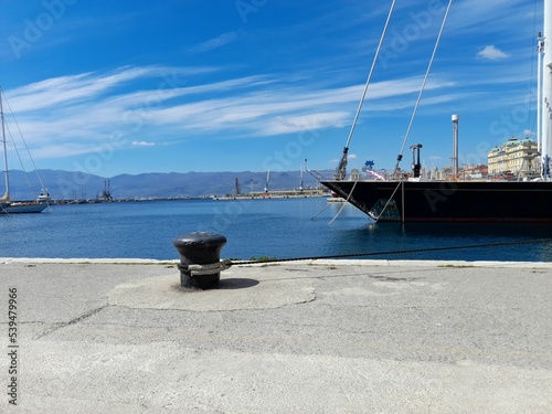 Boat parked near beach in background of buildings photo