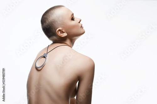 beautiful woman with short haircut. Back of naked bald Girl with Necklace