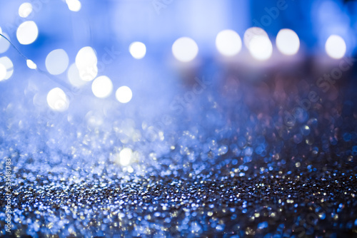 Abstract blue glitter background with bokeh lights. Banner for shiny celebrations.