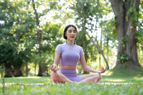Close up hands. Woman do yoga relax outdoor. Woman exercising pose vital and meditation for fitness lifestyle club at the outdoors nature background. Healthy and Yoga Concept.
