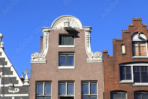 Historic House Gable Close Up in Nieuwezijds Voorburgwal Street in Amsterdam, Netherlands photo