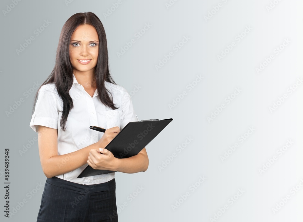 Happy businesswoman working with clipboard. Happy businesswoman working with clipboard.