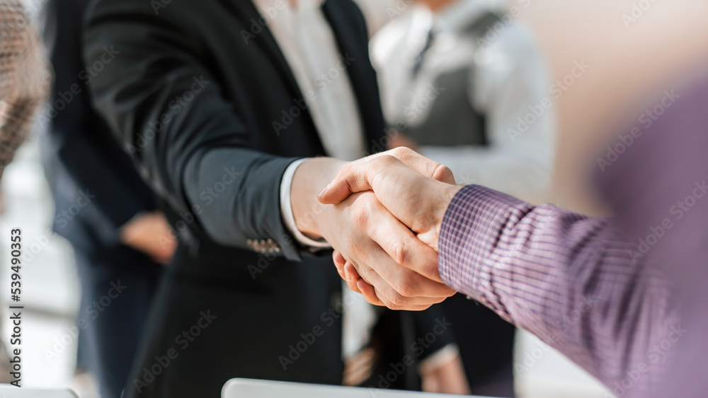 close up. young casual business people shaking hands with each