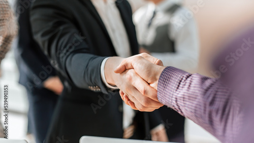 Obraz na płótnie close up. young casual business people shaking hands with each w salonie