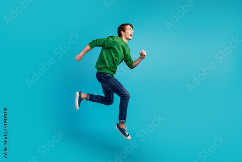 Full body photo of running jumping crazy man enjoying discounts isolated vivid color background