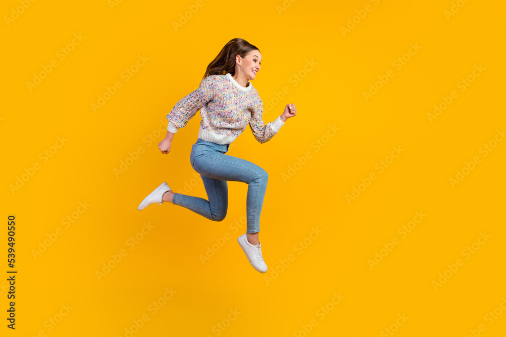 Full length profile photo of funny young lady run wear jeans sneakers isolated on vivid background