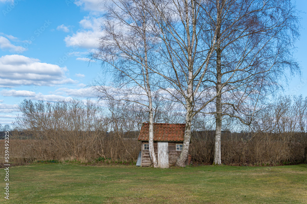 Fototapeta premium Little tiny lonely wooden house far away from city