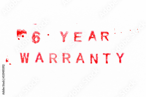 Red color ink rubber stamp in word 6 year warranty on white paper background