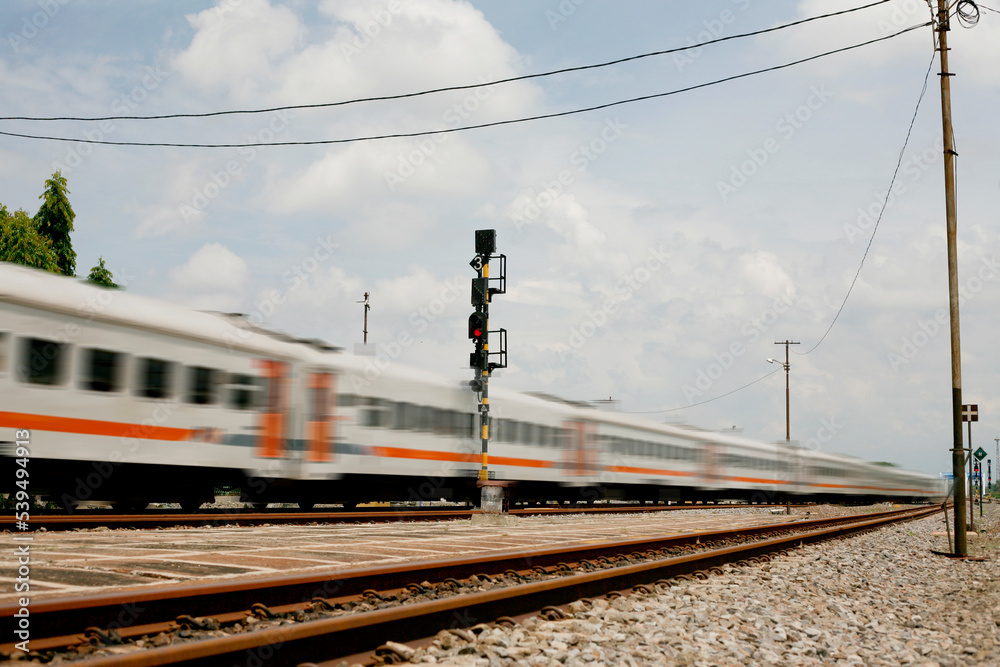 Fototapeta premium Motion blur passanger train arrived at Kertosono station in Java Island, Indonesia
